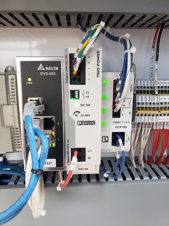 DIN-rail industrial Ethernet switch, Phoenix Contact power supply, and labeled field wiring