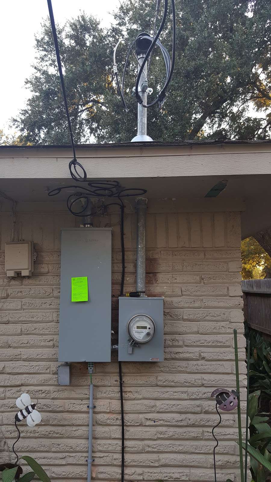 Residential service panel and meter with inspection tag on brick